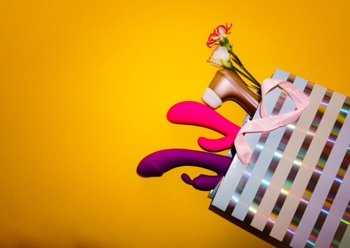 Masturbation May sex toys in a gift bag on yellow background