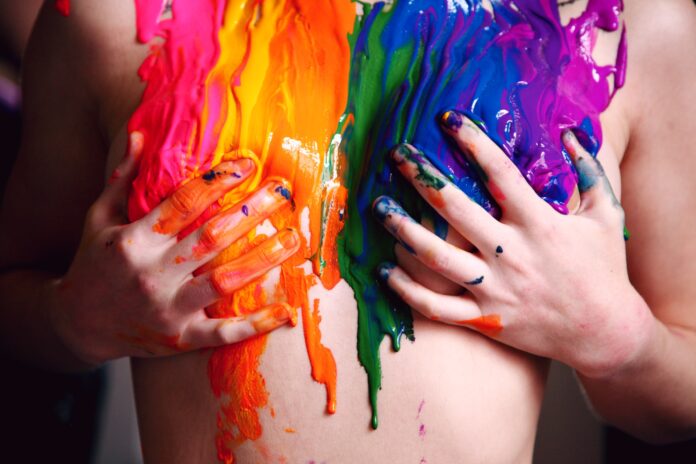 hands holding boobs on national coming out day with coming out quotes